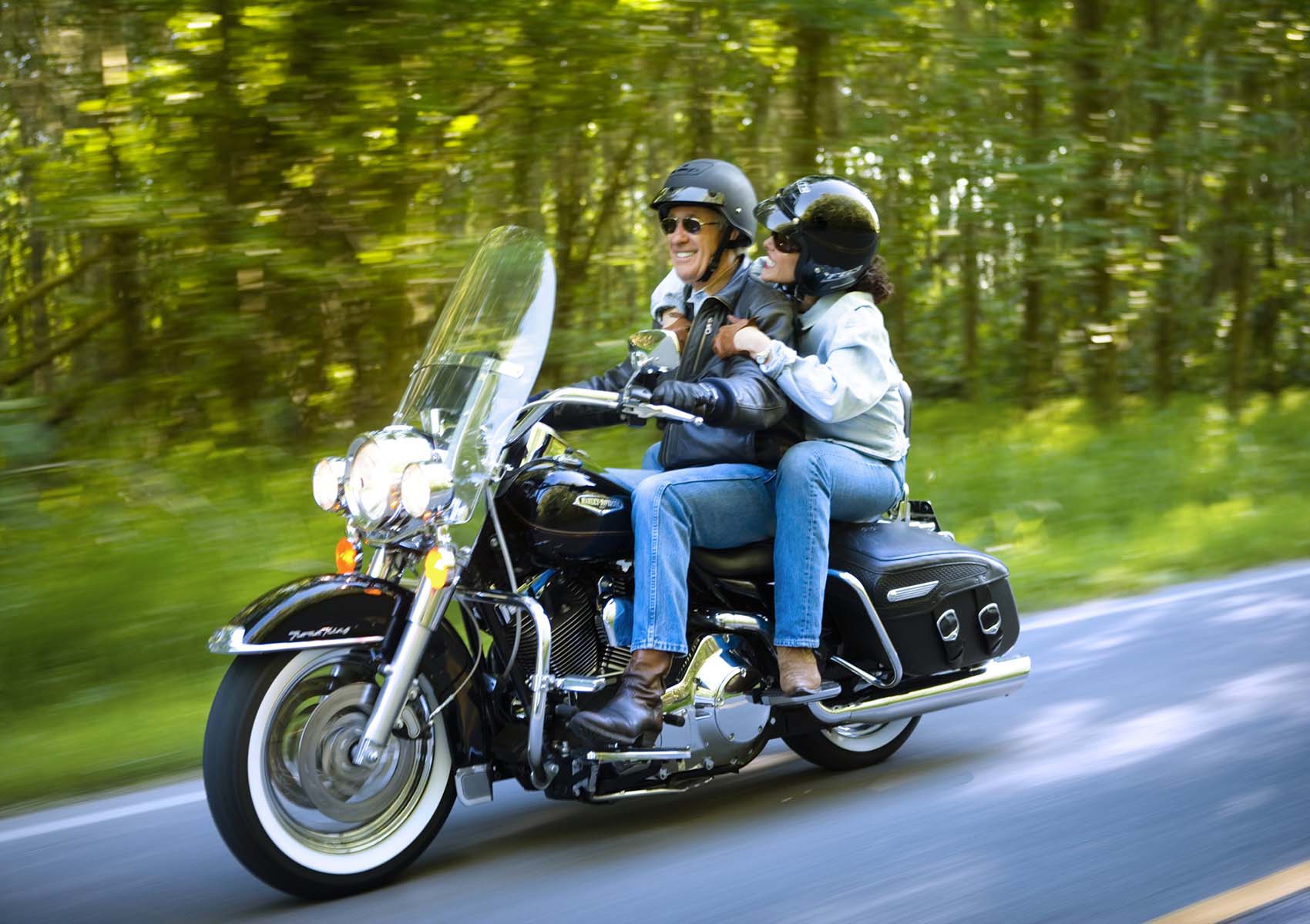 couple riding on motorcycle 