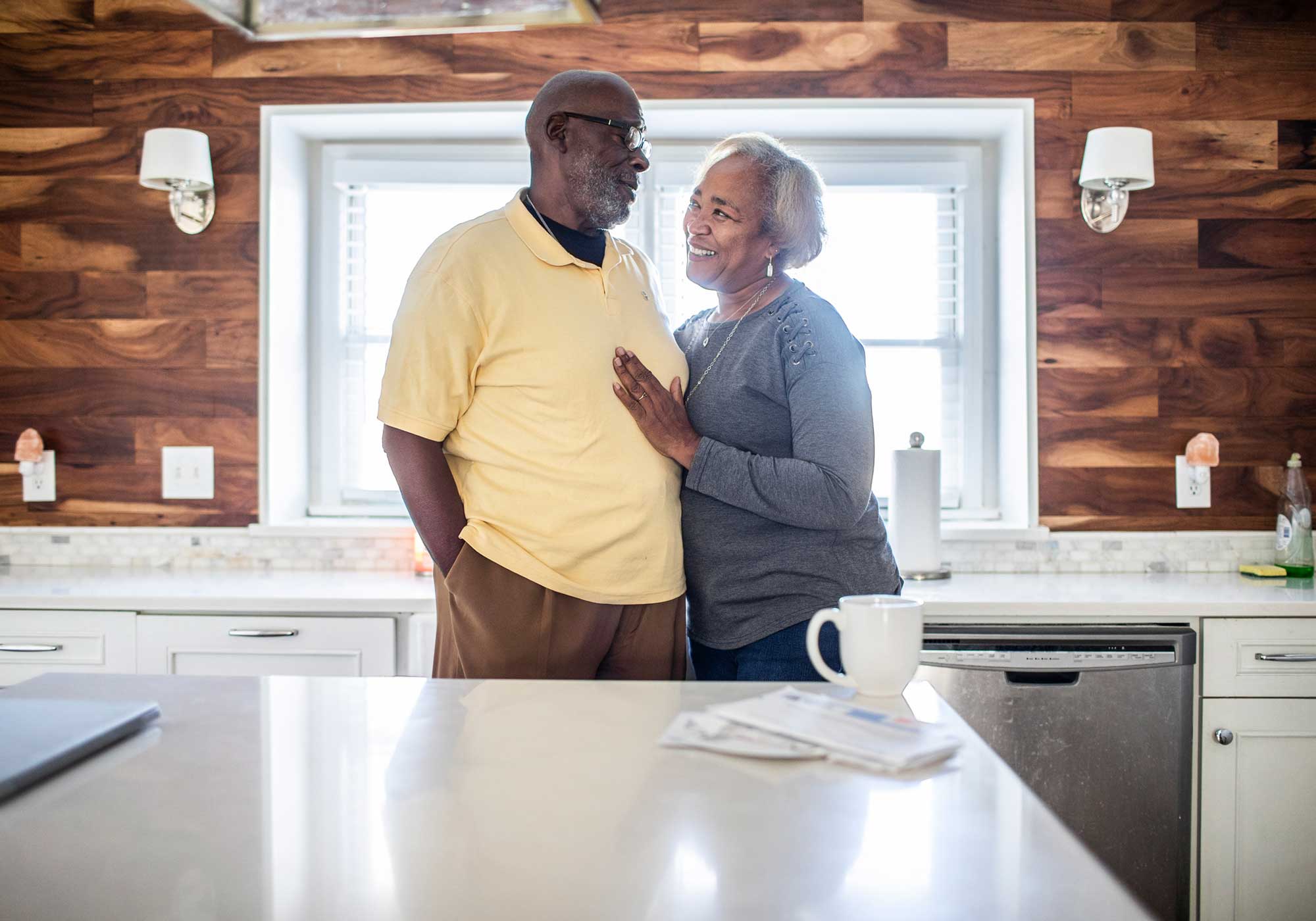 couple hugging while in kitchen