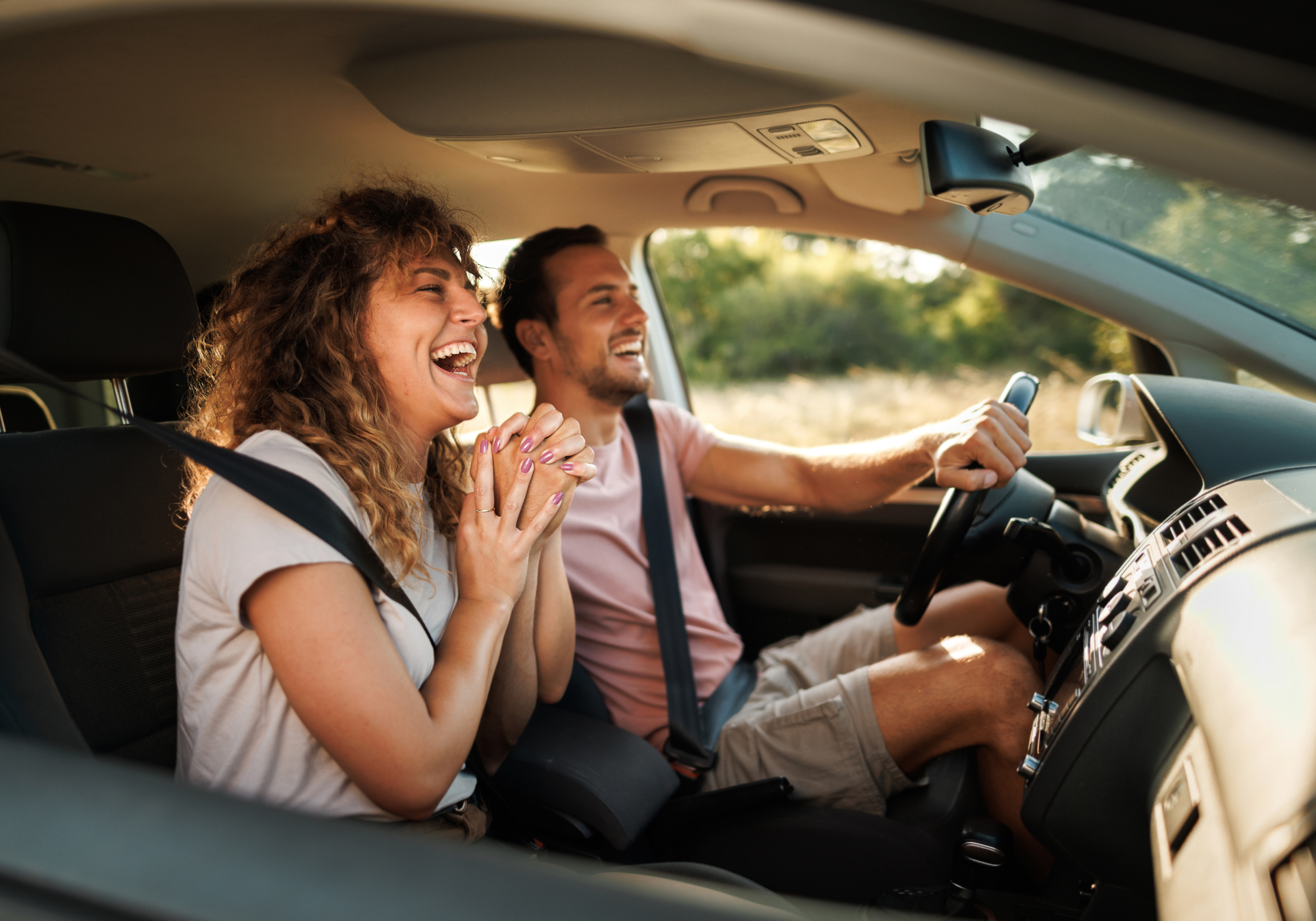 happy couple driving new car