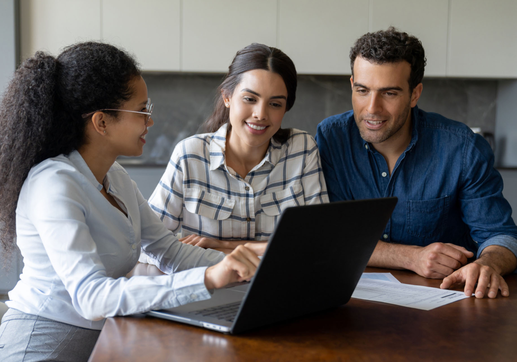 Couple consulting with mortgage lender about home purchase plans.