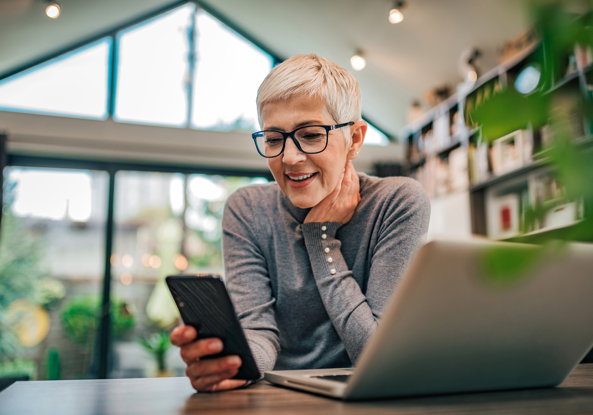 Smiling woman looking at her iPhone.