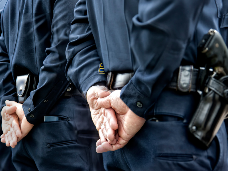 police hands behind back