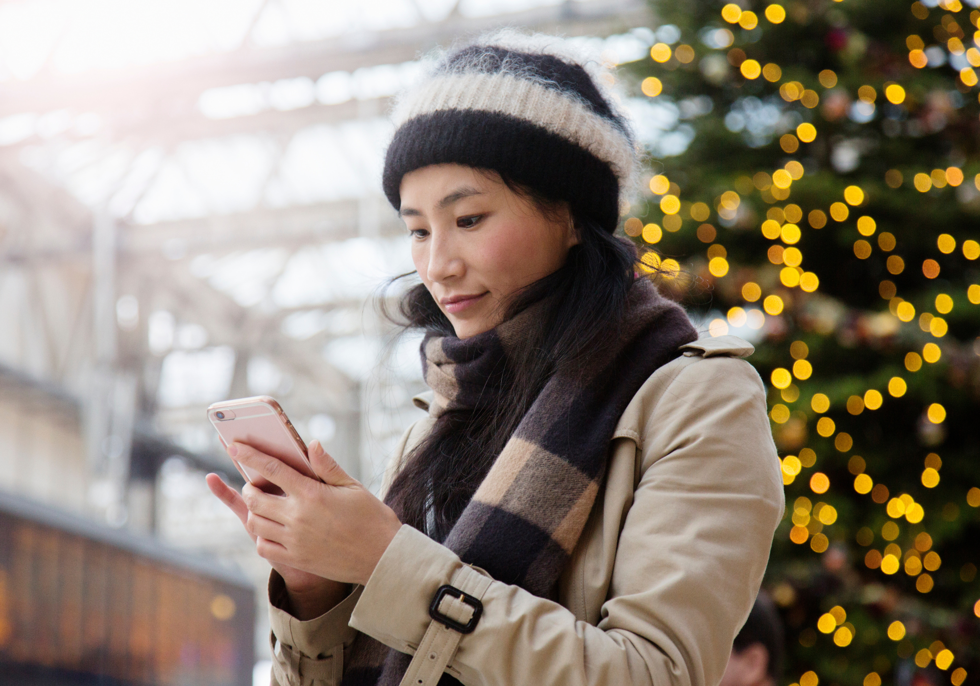 woman comparing flight prices on phone