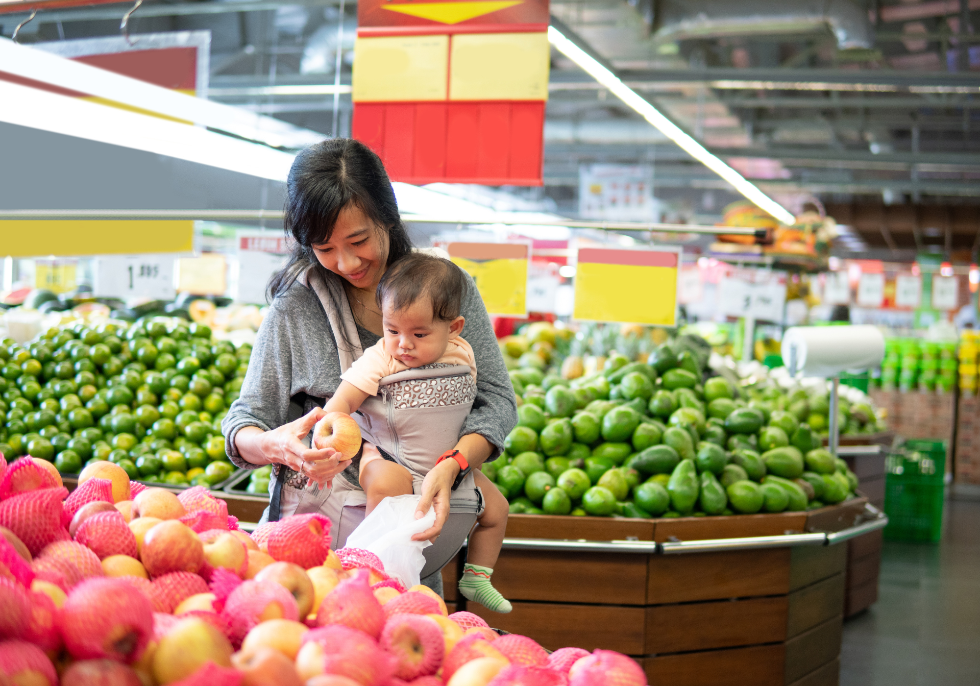 mother shopping for groceries with baby 