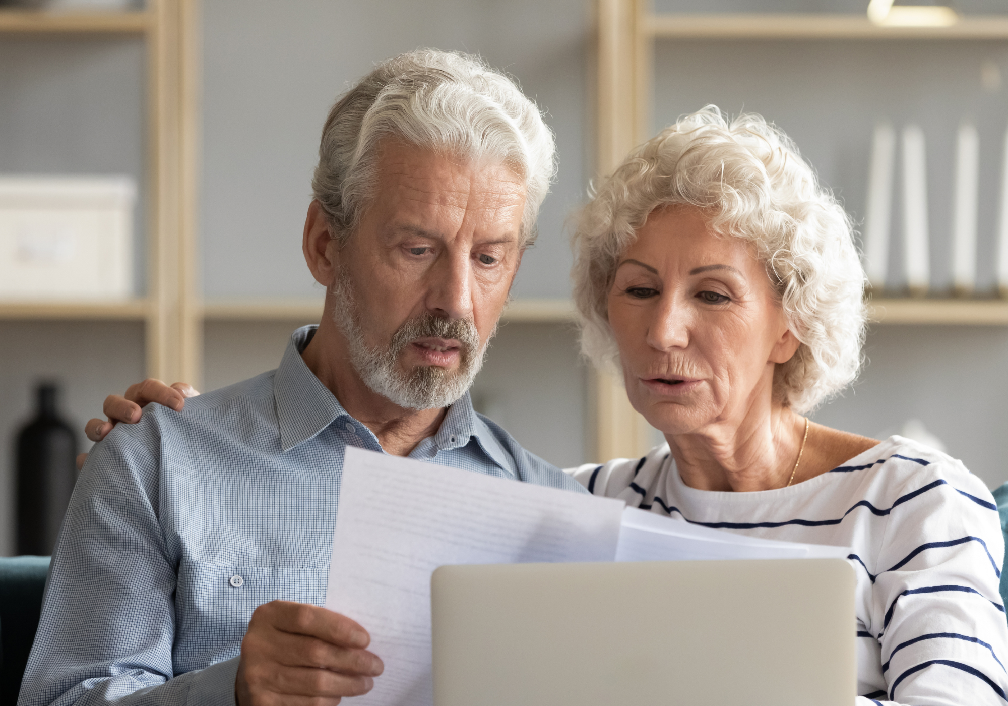 elderly couple reviewing financial fraud