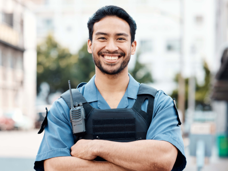 smiling police officer with arms folded