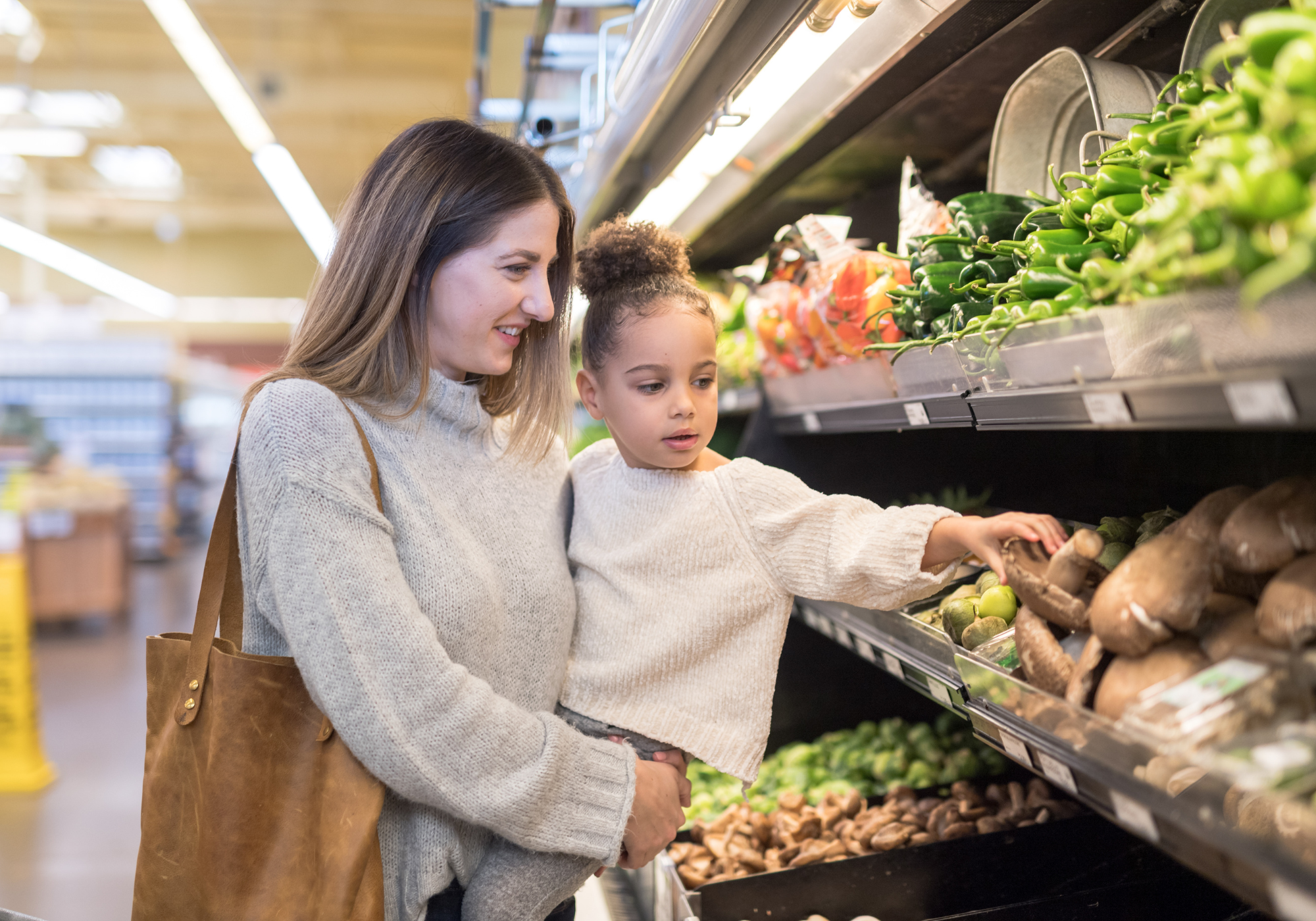 mother grocery shopping with daughter
