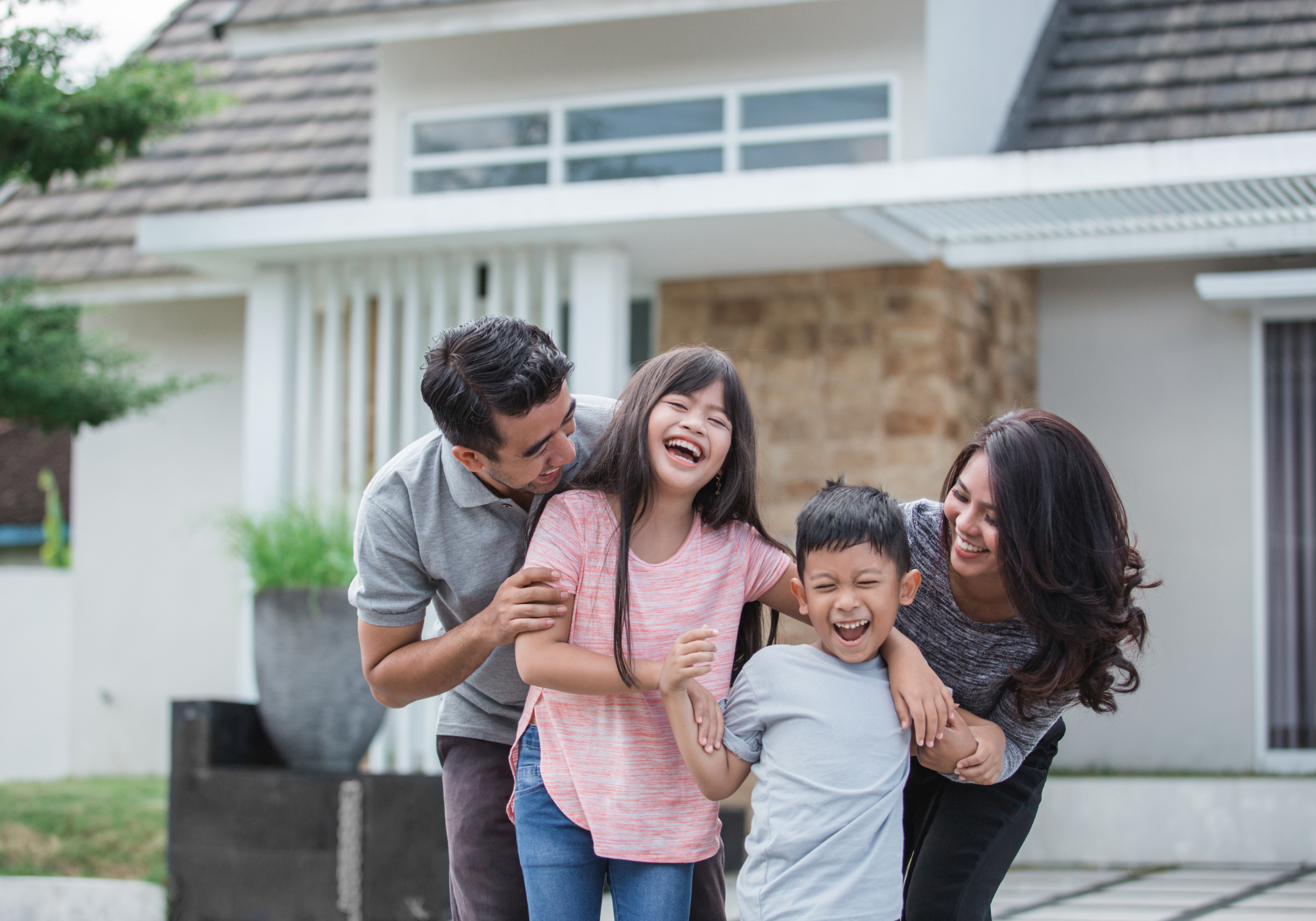 happy family outside new house